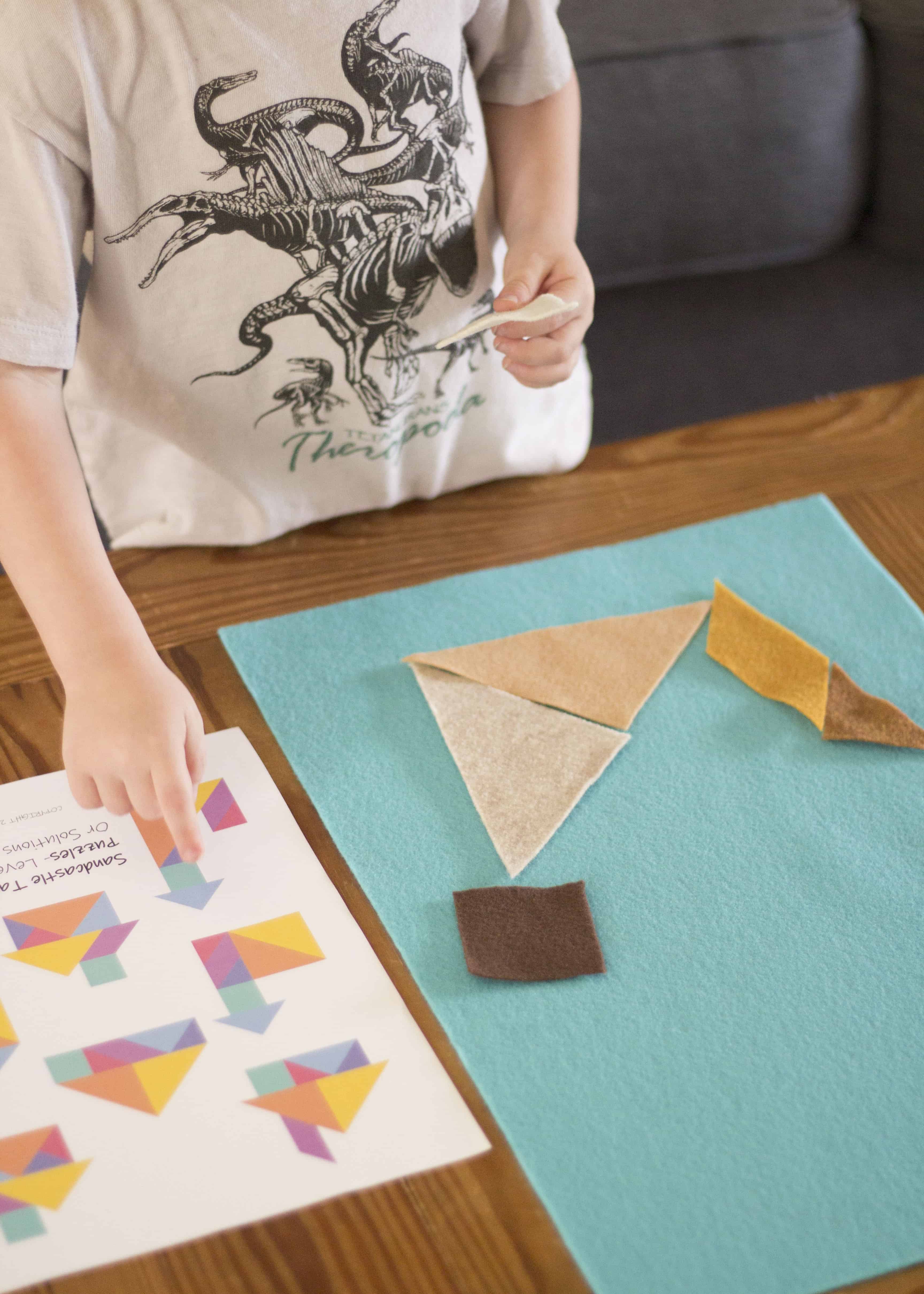 TODDLER LOOKING AT TANGRAM