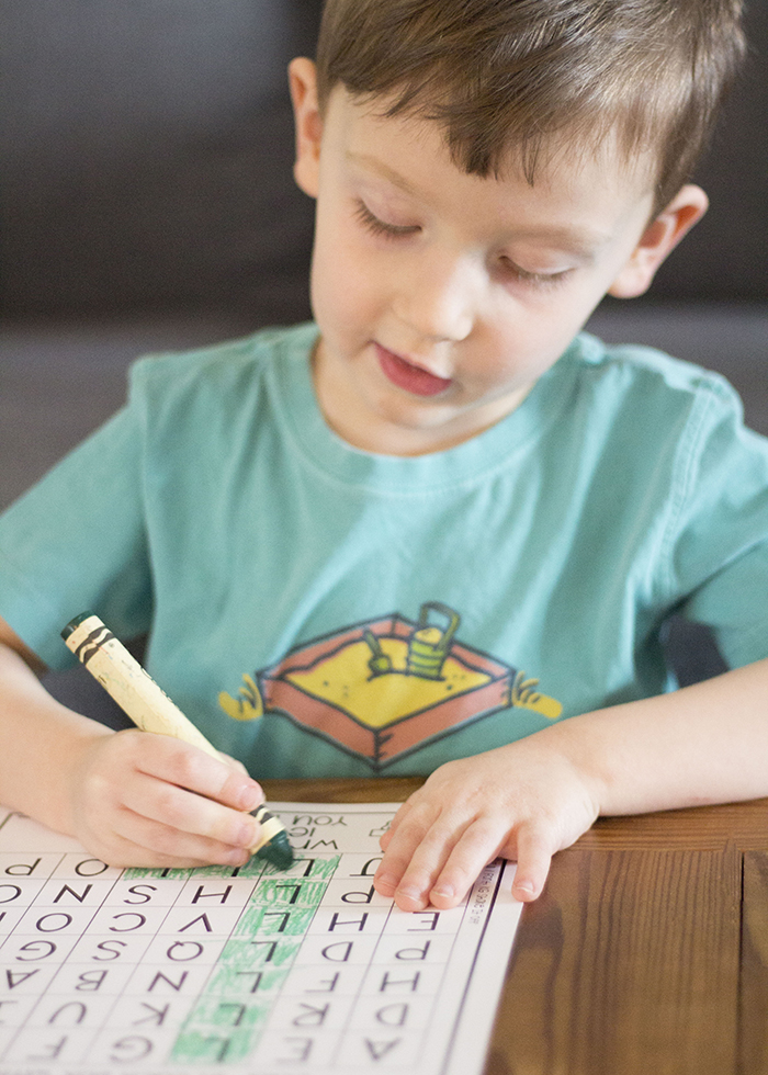 BOY COLORING WITH CRAYON